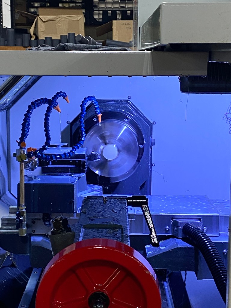 The inside of a CNC machine as a part spins.